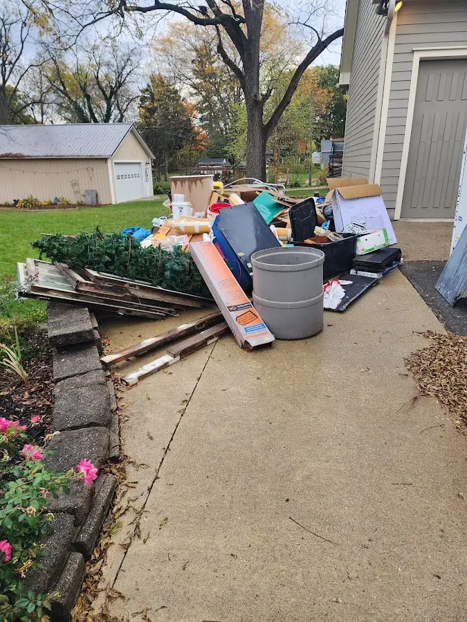 Dumpster being loaded with debris for Roofing Dumpster Rental in Buckhead